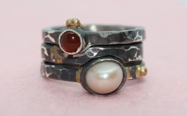 Parel en carneool in gezwart zilver en goud.