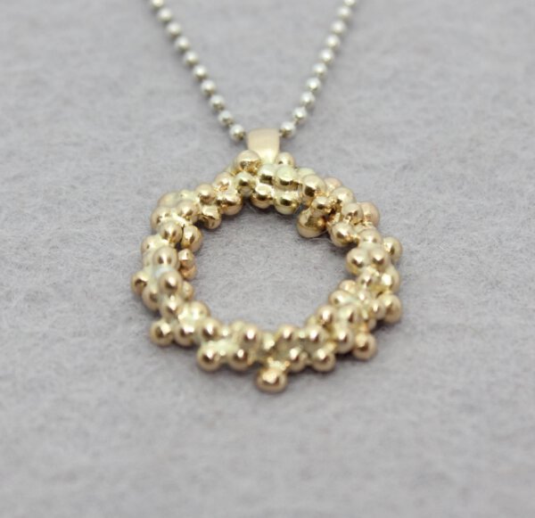 zilveren collier met hanger van omgesmolten oud goud