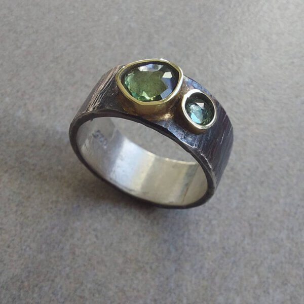 Geoxideerd zilveren ring met groene tourmalijn en korund in gouden zetting